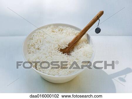 Bowl of rice and wooden spoon View Large Photo Image Stock Image - Bowl of rice and wooden spoon. Fotosearch