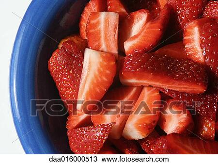 Stock Image - Bowl of sliced strawberries. Fotosearch