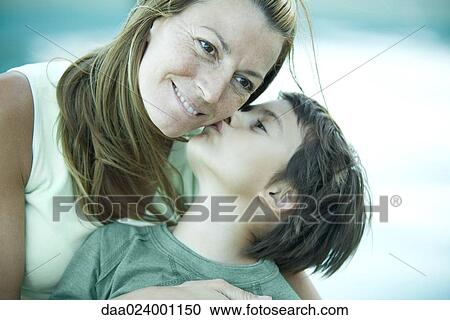 Boy and mother, boy kissing woman's cheek View Large Photo Image Stock Image - Boy and mother, boy kissing woman's cheek. Fotosearch