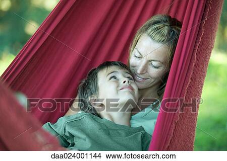 Picture - Boy and mother in hammock, smiling at each other. Fotosearch