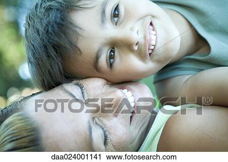 Boy and mother lying down, cheek to cheek View Large Photo Image Stock Image - Boy and mother lying down, cheek to cheek. Fotosearch