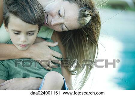 Boy and mother, woman hugging son from behind View Large Photo Image Stock Image - Boy and mother, woman hugging son from behind. Fotosearch