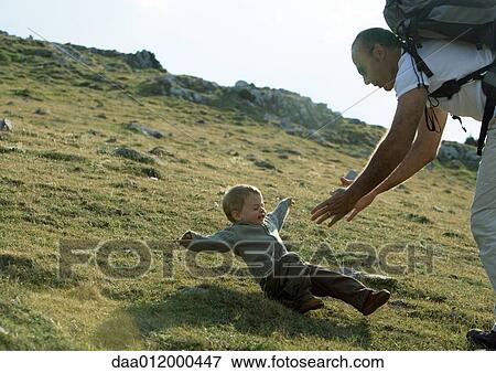 Stock Photo - Boy falling as father reaches for him. Fotosearch