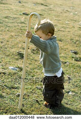 Stock Photo - Boy holding cane. Fotosearch