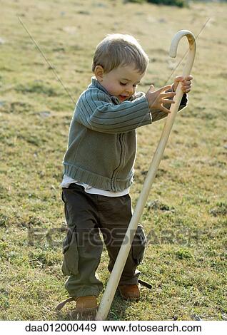 Stock Photo - Boy holding cane. Fotosearch