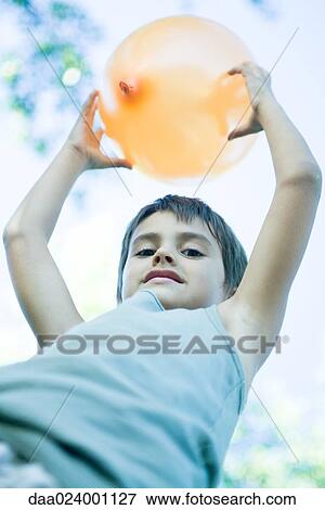 Boy holding up balloon View Large Photo Image Stock Photo - Boy holding up balloon. Fotosearch