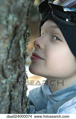 Boy hugging tree, close-up View Large Photo Image Picture - Boy hugging tree, close-up. Fotosearch