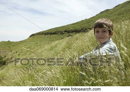 Boy in meadow, portrait View Large Photo Image Picture - Boy in meadow, portrait. Fotosearch