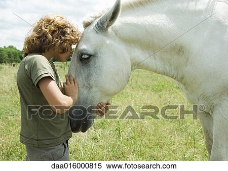 Boy kissing horse View Large Photo Image Stock Photography - Boy kissing horse. Fotosearch