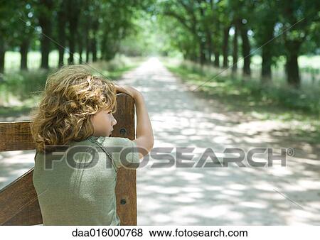 Boy leaning on gate, facing dirt road, rear view View Large Photo Image Stock Photo - Boy leaning on gate, facing dirt road, rear view. Fotosearch