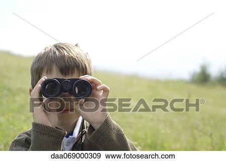 Boy looking through binoculars View Large Photo Image Stock Photo - Boy looking through binoculars. Fotosearch