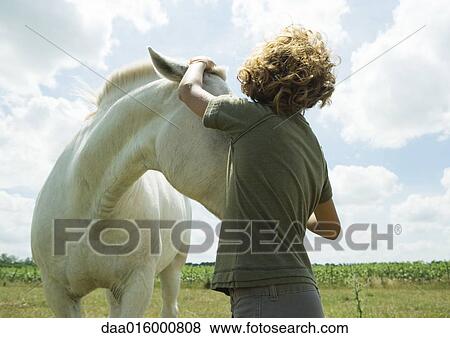 Boy petting horse View Large Photo Image Stock Photo - Boy petting horse. Fotosearch