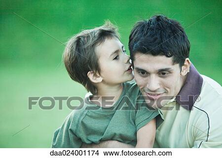 Boy with father, whispering into his ear View Large Photo Image Picture - Boy with father, whispering into his ear. Fotosearch