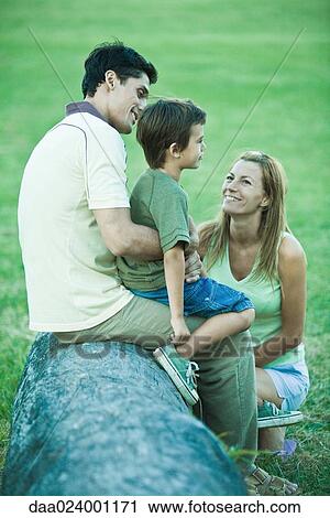 Boy with parents, sitting on father's lap View Large Photo Image Stock Image - Boy with parents, sitting on father's lap. Fotosearch
