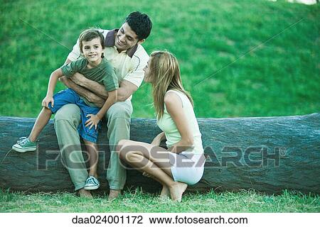 Boy with parents, sitting on father's lap View Large Photo Image Stock Image - Boy with parents, sitting on father's lap. Fotosearch