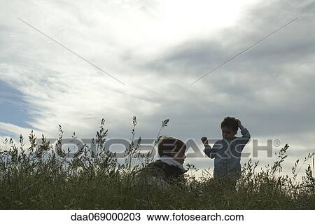 Boys in meadow View Large Photo Image Stock Image - Boys in meadow. Fotosearch
