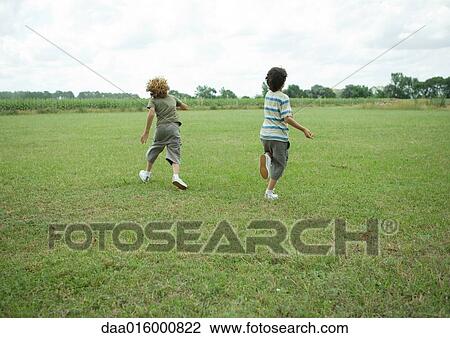Boys running in field View Large Photo Image Stock Image - Boys running in field. Fotosearch