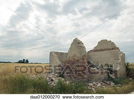 Stock Image - Brick building in ruins in countryside. Fotosearch