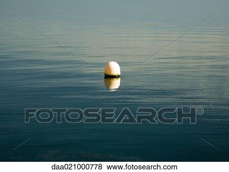 Buoy floating in water View Large Photo Image Stock Photo - Buoy floating in water. Fotosearch