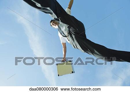 Stock Photograph - Businessman jumping in air carrying briefcase, directly below. Fotosearch