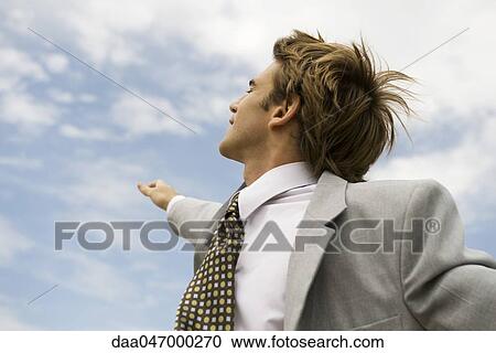 Businessman raising arm reaching towards sky View Large Photo Image Stock Image - Businessman raising arm reaching towards sky. Fotosearch