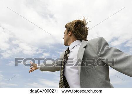 Businessman reaching towards sky View Large Photo Image Stock Image - Businessman reaching towards sky. Fotosearch