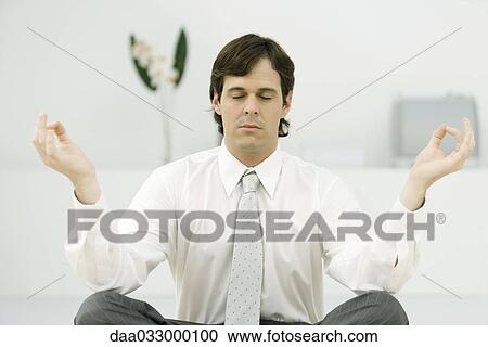 Businessman sitting in lotus position, eyes closed View Large Photo Image Stock Image - Businessman sitting in lotus position, eyes closed. Fotosearch