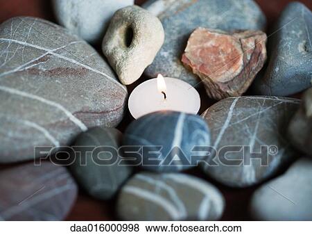 Candle and stones View Large Photo Image Stock Photo - Candle and stones. Fotosearch
