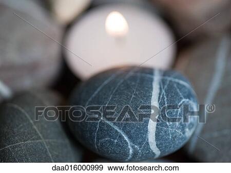 Candle and stones View Large Photo Image Stock Photo - Candle and stones. Fotosearch