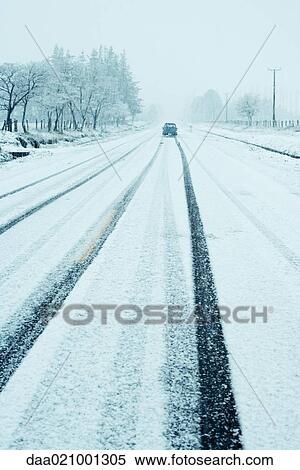 Car on road going through snowy landscape View Large Photo Image Stock Photography - Car on road going through snowy landscape. Fotosearch