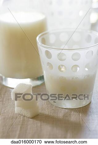 Stock Image - Carafe and glass of eggnog, with sugar cubes. Fotosearch