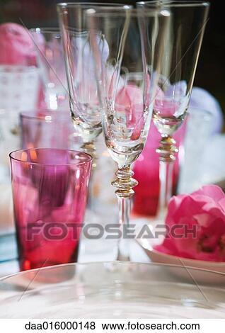 Champagne glasses on set table View Large Photo Image Stock Photo - Champagne glasses on set table. Fotosearch