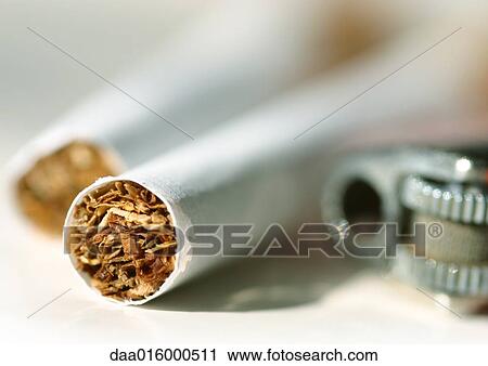 Stock Image - Cigarettes and lighter, extreme close-up. Fotosearch