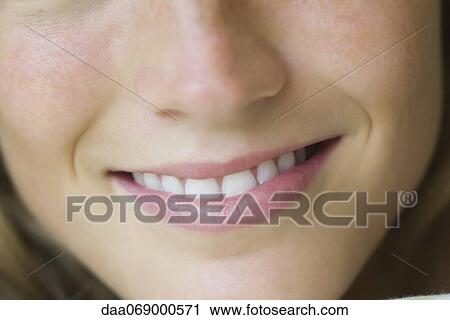 Stock Image - Close-up of young woman's smile. Fotosearch
