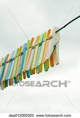 Stock Photography - Clothes pegs hanging on clothesline. Fotosearch
