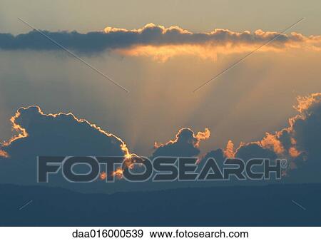 Stock Photo - Cloudscape at sunset. Fotosearch