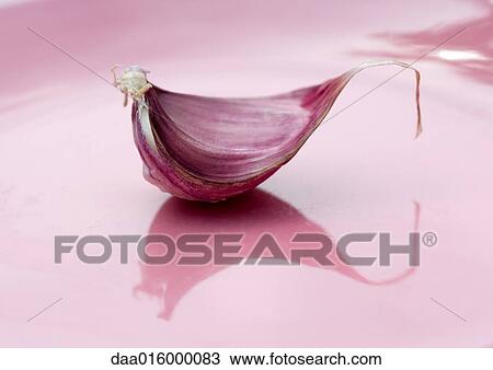 Stock Image - Clove of garlic on plate. Fotosearch