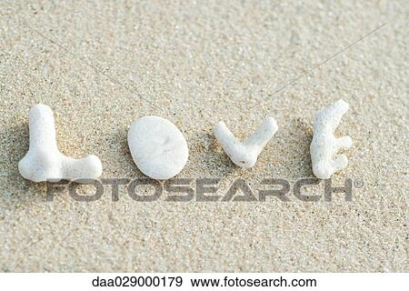 Coral pieces spelling out the word love on the beach View Large Photo Image Stock Photo - Coral pieces spelling out the word love on the beach. Fotosearch