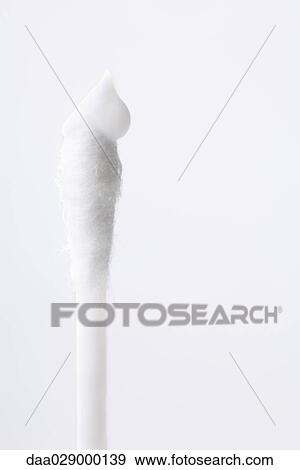 Cotton swab with dollop of cream, close-up View Large Photo Image Stock Photo - Cotton swab with dollop of cream, close-up. Fotosearch