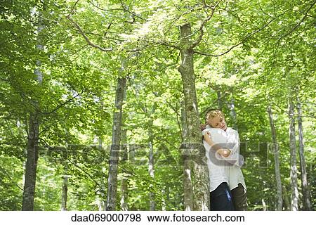 Couple embracing in woods View Large Photo Image Stock Photo - Couple embracing in woods. Fotosearch