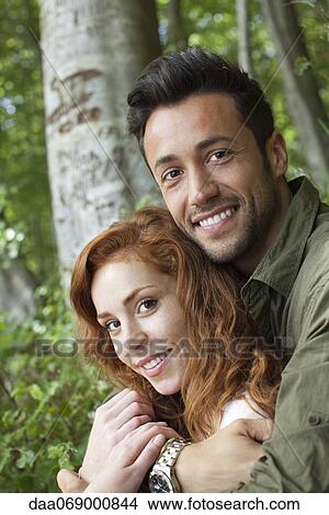 Couple embracing outdoors, portrait View Large Photo Image Picture - Couple embracing outdoors, portrait. Fotosearch