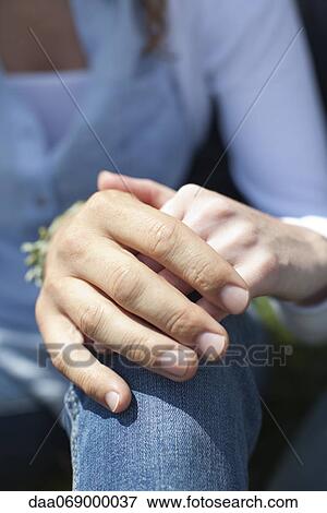 Stock Photo - Couple holding hands, cropped. Fotosearch