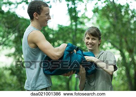 Couple holding sleeping bag together View Large Photo Image Stock Photograph - Couple holding sleeping bag together. Fotosearch