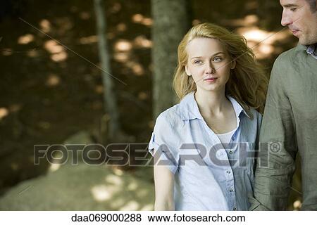 Couple in woods, focus on woman View Large Photo Image Stock Photo - Couple in woods, focus on woman. Fotosearch