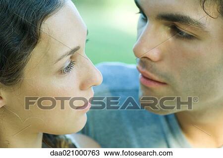 Stock Image - Couple looking at each other, extreme close-up. Fotosearch