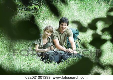 Couple of hikers in grass View Large Photo Image Stock Image - Couple of hikers in grass. Fotosearch