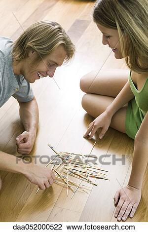 Couple playing pick up sticks together View Large Photo Image Stock Image - Couple playing pick up sticks together. Fotosearch