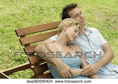 Couple relaxing together on lounge chair View Large Photo Image Picture - Couple relaxing together on lounge chair. Fotosearch