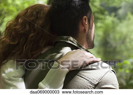 Couple relaxing together, woman resting head on man's shoulder, rear view View Large Photo Image Stock Image - Couple relaxing together, woman resting head on man's shoulder, rear view. Fotosearch