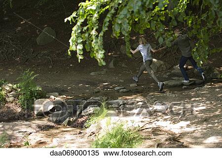 Stock Photography - Couple running in woods. Fotosearch